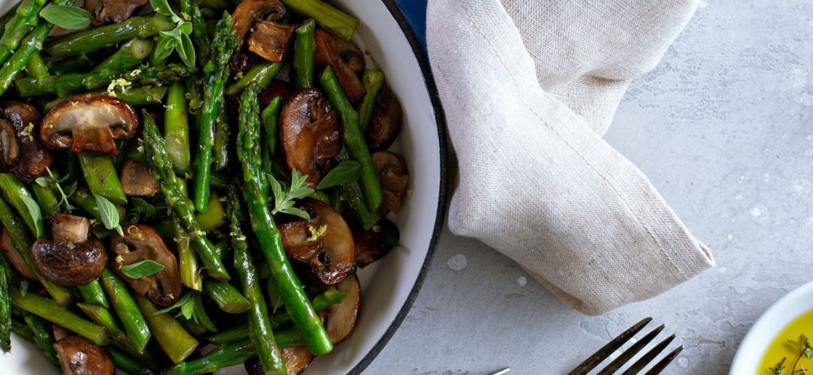 Asparagus and mushrooms sauteed in a cast iron pan with lemon zest