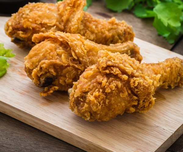 Crispy fried chicken on wooden cutting board and dip sauce